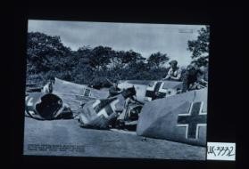 Wrecked German raiders brought down by the R.A.F. and anti-aircraft gunners. Taking scrap metal from the planes