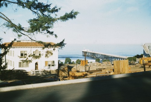 Construction material near Ritter Hall for the Ritter Hall addition, with the Scripps Pier in the background. 1955