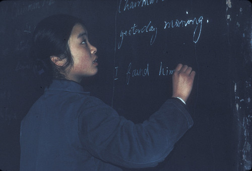 Beijing University Student Writing Answers on the Board in an English Class