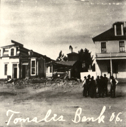 The remains of the Tomales Bank (middle) are observed by a group, following the earthquake of April 18, 1906, Marin County, California [photograph]