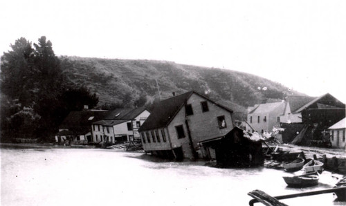 The Flagstaff Inn and the Bolinas Tavern, tipped into the Bolinas Lagoon during the earthquake of April 18, 1906, Marin County, California [[photograph]