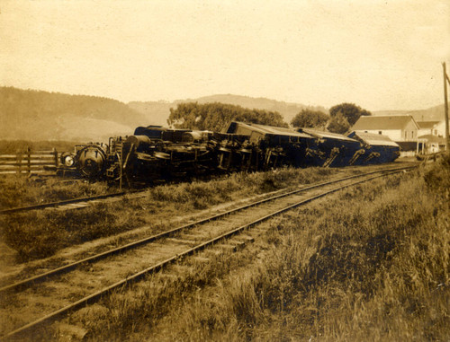 The Northwestern Pacific train, leaving Point Reyes Station and heading to Sausalito, tipped over during the April 18, 1906 earthquake, Marin County, California [photograph]