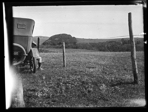 Native pasture improvement on the Vogenson Ranch in Olema, Marin County, in March 1924. M.B. Boissevain is pictured sitting on the running board of his Model T. [photograph]