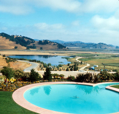 Frank Lloyd Wright-designed Marin County Civic Center grounds and patio from the Administrative Building's second floor cafeteria, east side of the Administration Building looking northeast, San Rafael, California, 1962 [photograph]