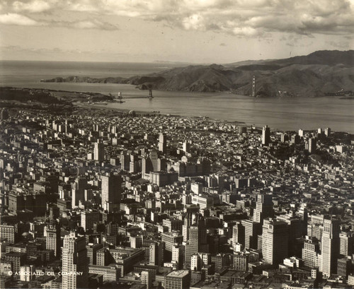 View from San Francisco, looking towards the construction of the Golden Gate Bridge, with the north (Marin) tower visible in the distance, March, 1935 [photograph]