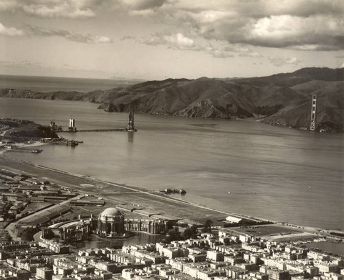 View from San Francisco during the construction of the Golden Gate Bridge, with the Palace of Fine Arts in the foreground, March, 1935 [photograph]