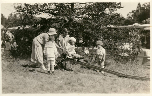 Children playing on the slide at the annual Grape Festival at the Kent Family home, circa 1921 [photograph]