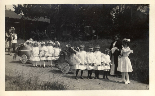 Students and their teacher pose on their way to the second annual May Day celebrations in Kentfield, California, May, 1910 [photograph]