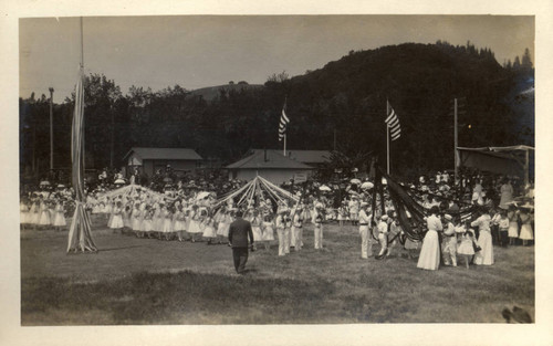 Children prepare to weave streamers around may poles during the second annual May Day celebrations in Kentfield, California, May, 1910 [photograph]
