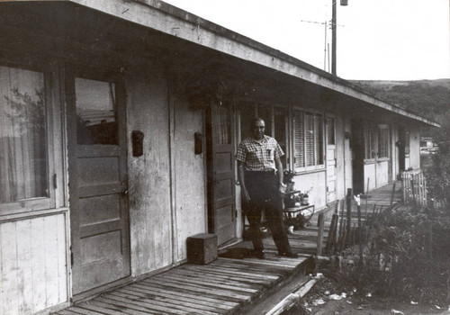 Long-time Marin City resident and community leader Jesse Berry, in front of World War II-era housing, circa 1960 [photograph]