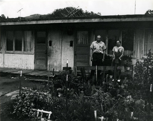 Long-time Marin City resident and community leader Jesse Berry and his wife Flossie, in front of World War II-era housing, circa 1960 [photograph]