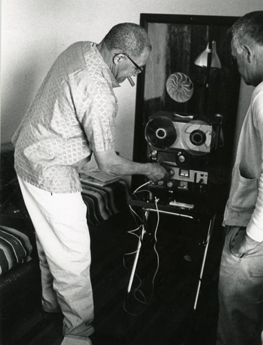 Long-time Marin City resident and community leader Jesse Berry in his new home, with a guest, circa 1963 [photograph]