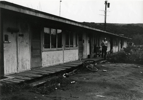 Long-time Marin City resident and community leader Jesse Berry, in front of World War II-era housing, circa 1960 [photograph]