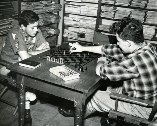 Two children enjoy a game of chess at the Kenfield-Ross Branch of the Marin County Free Library, circa 1952 [photograph]