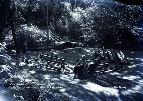 Outdoor fireplace and seating area, Camp Duncan, 1946 [postcard negative]