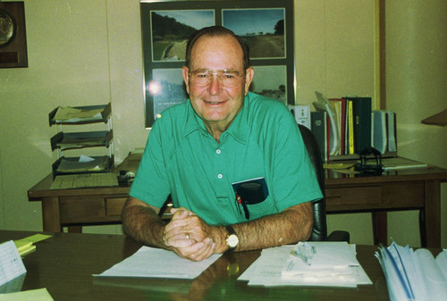 Former Marin County Parks Director and Open Space District General Manager Don Dimitratos at his desk at the Marin County Civic Center, San Rafael, 1985 [photograph]