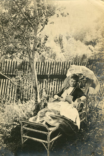 Visitor relaxing with a book on the grounds of the Blithedale Hotel, Mill Valley, circa 1889 [photograph]