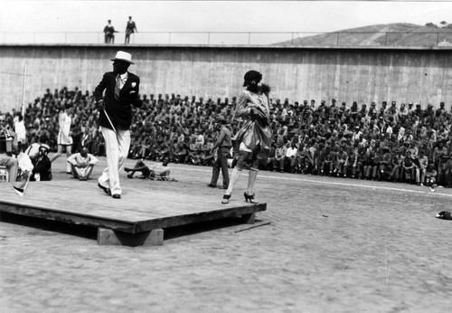 Stage entertainment, including a male dancer in female dress, San Quentin Little Olympics Field Meet, 1930 [photograph]