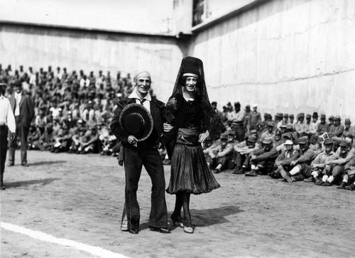 Two male entertainers in Spanish costume (one in female dress), San Quentin Little Olympics Field Meet, 1930 [photograph]