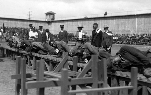 Tug-of-war competition with officials looking on, San Quentin Little Olympics Field Meet, 1930 [photograph]