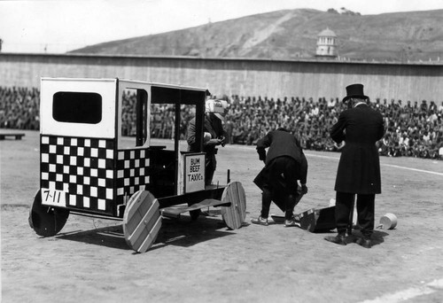 Entertainment featuring clowns with a handmade taxi, San Quentin Little Olympics Field Meet, 1930 [photograph]