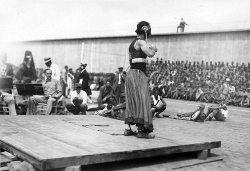 Stage entertainment, featuring a male dancer in female dress, San Quentin Little Olympics Field Meet, 1930 [photograph]