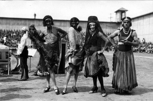 Stage entertainment with four male dancers in female dress, San Quentin Little Olympics Field Meet, 1930 [photograph]