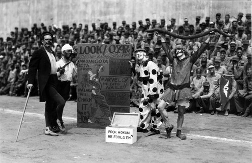 Skit with clowns and snake charmer, San Quentin Little Olympics Field Meet, 1930 [photograph]