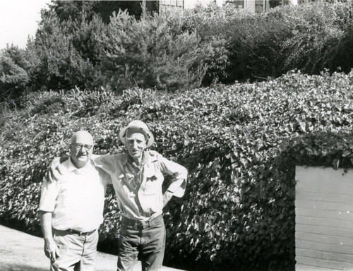 Dr. Leo L. Stanley(right) standing with a man identified as Pat, circa 1965 [photograph]