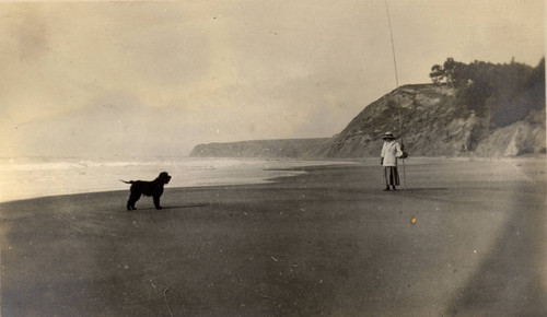 Una Boyle and dog walking on Bolinas Beach, Bolinas, California, March 1913 [photograph]