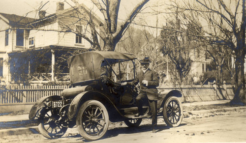 Dr. Henry Orton Howitt beside his car in San Rafael, California, February 1914 [photograph]