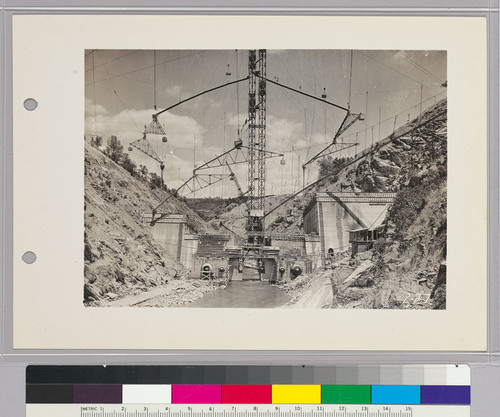 Pardee Dam,--Construction View,--Showing main chute at right, which carries concrete mixture from plant on hill to base of tower. Mixture is then raised to hoppers, shown in tower, then down through chutes hung on counter-weights and finally through pipes called "elephant's trunks," moved where concrete is to be placed