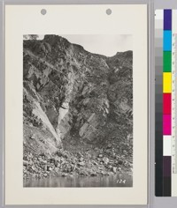 Showing blasting cut-off trench into south bank of canyon. The foundation of the up-stream face of the dam is "keyed" into this cut-off trench