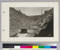 Showing flume, by-passing river, and upper and lower coffer dams blocking off river channel. Water will be pumped out of river channel and foundation of dam poured