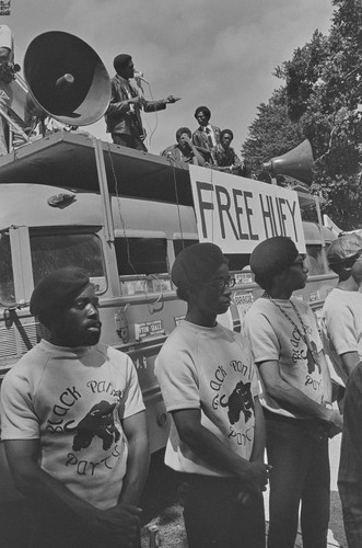 Black Panthers from Los Angeles, guarding speaker's platform; Bobby Seale, speaking at Free Huey Rally, DeFremery Park, Oakland, CA, #9 from A Photographic Essay on The Black Panthers