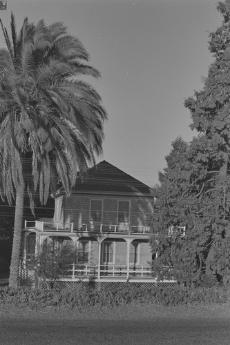 Two story house with palm tree, Walnut Grove