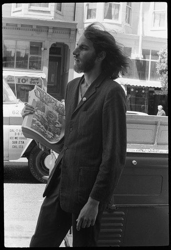 Another man selling Oracle, leaning on truck, Haight-Ashbury 1967