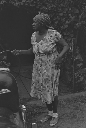 Black woman washing car, from Walnut Grove