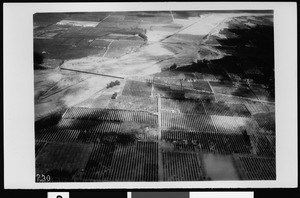 Aerial view of floodplains, showing break in levee, Santa Ana, 1938