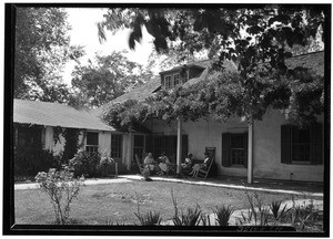 People lounging on the porch of Colonel Purcell's adobe house in San Gabriel, June 4, 1930