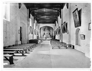 Interior view of the Mission San Gabriel Arcangel, looking down the center aisle towards the alter, San Gabriel, ca.1900