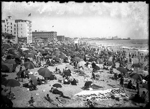 Bathers under umbrellas on the beach at Santa Monica