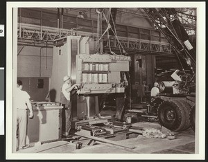 Workers lowering machinery inside the Northrop Corporation's Plant, ca.1950