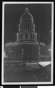 Exterior of City Hall at night lined with stringed lights in San Francisco, ca.1900