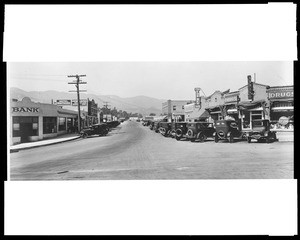Street lined with automobiles in Montrose, 1924