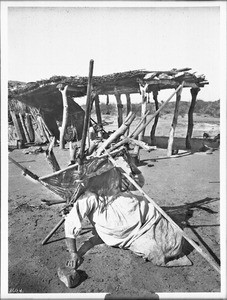 Pima Indian woman, Si-Rup, sitting down before carrying firewood in her "Kathak", Pima, Arizona, 1904