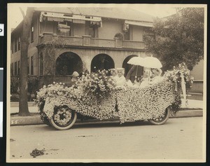 Flower decked auto in a (Fiesta?) parade, ca.1930