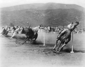 Cowboys racing their horses at a rodeo, Santa Barbara, ca.1920