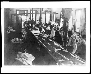 Men working inside Tom William's tailor shop on Main Street in Los Angeles, ca.1880-1889