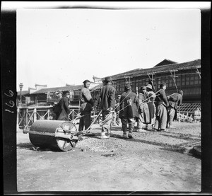 Men pulling a pavement-roller in China, ca.1900